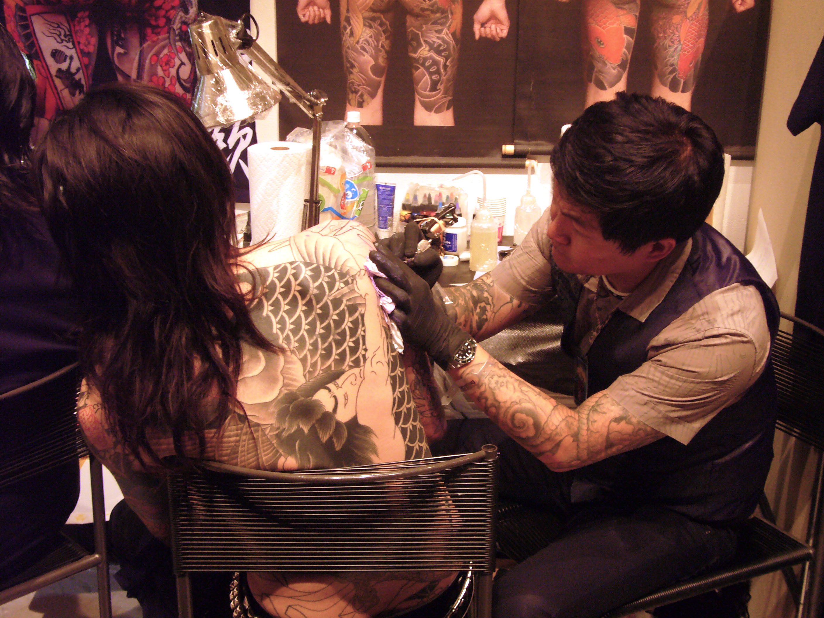Tattoo artist Horian inking a customer at King of Tattoo in Tokyo