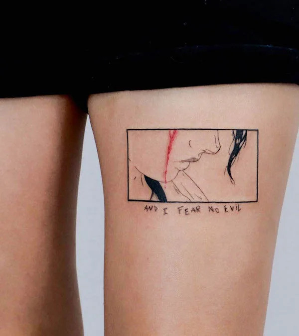 Comic-style tattoo with the quote Fear No Evil on the thigh, by @modoink_gary, blending art with a protective mantra