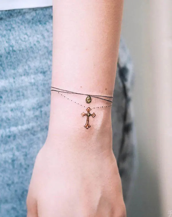 Elegant cross bracelet tattoo for women design by @olgacaca