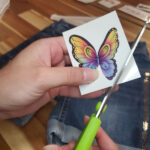 Cutting a butterfly tattoo for fabric application