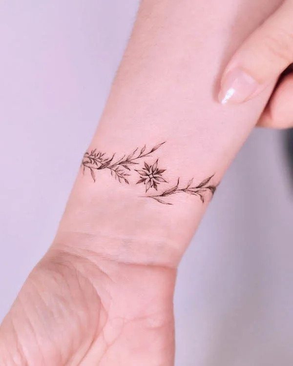 Dainty star and floral bracelet tattoo design by @tattooist_gaon
