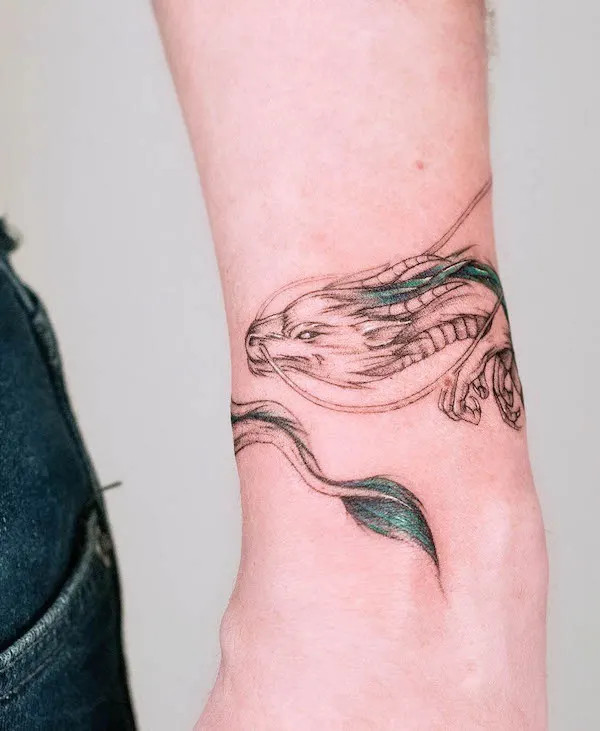 Detailed dragon bracelet tattoo by @olka_tattoo