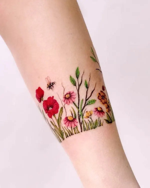 Elaborate flower garden bracelet tattoo design by @maiko.only