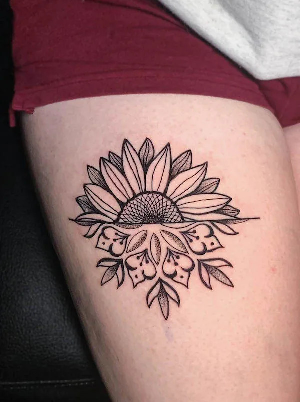 Black and grey sunflower tattoo on the thigh, by @daveinks.88, symbolizing positivity and creativity