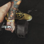 A close-up of a new tattoo showing the silver skin healing phase.