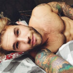 Man with intricate geometric tattoos on his arm
