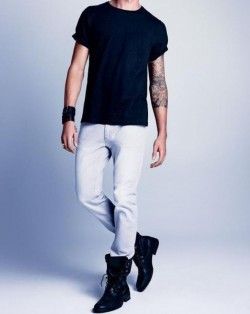 A person with a side-lace up jeans and an animal print top at the tattoo convention.