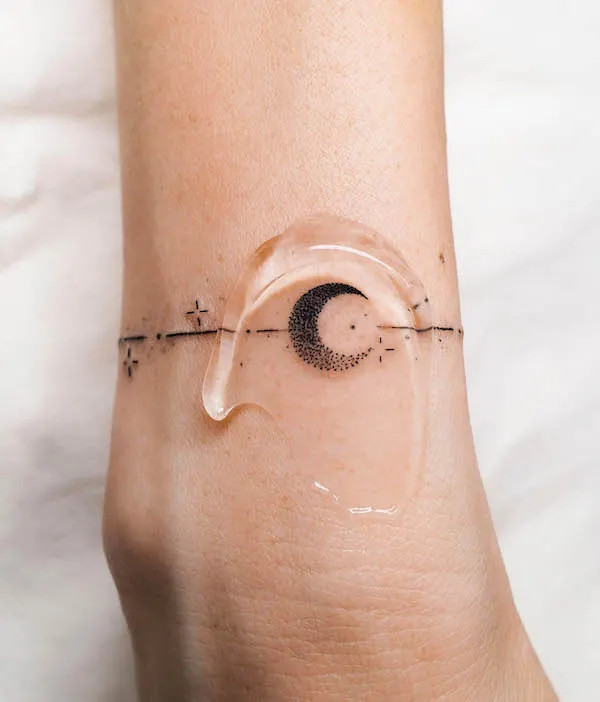 Feminine moon phases bracelet tattoo for women by @oitattooer