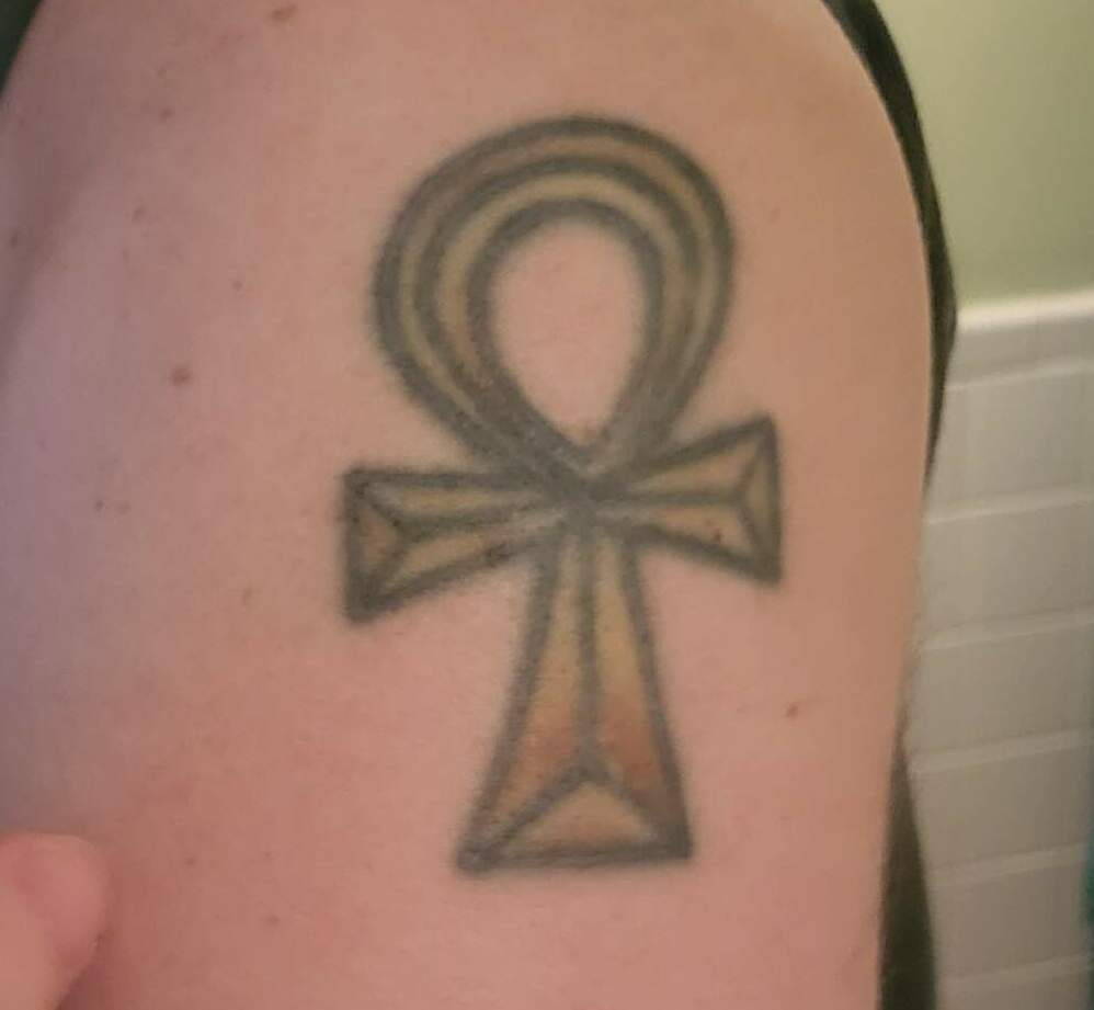 Ankh tattoo on a person's arm, symbolizing rebirth and new beginnings