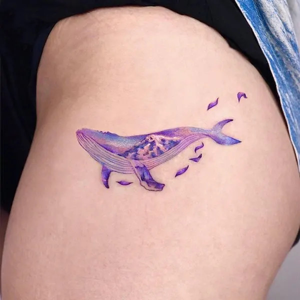 Purple whale tattoo on the thigh, by @ornot_tattoo, symbolizing wonder and the vastness of the sea