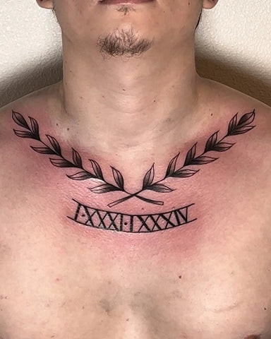 Roman numerals marking a significant date on the collarbone