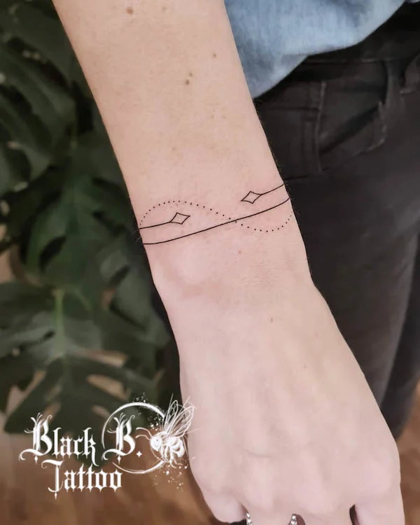 Essential simple bracelet tattoo by @britt_blackbtattoo