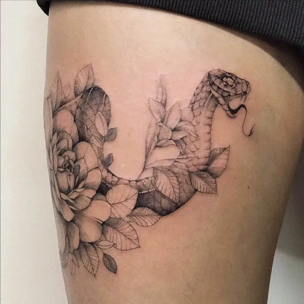 Snake and flowers thigh band tattoo, by @dnq.tattoo, blending protection with natural beauty