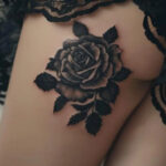 Tattoo on thigh with a person touching their thigh
