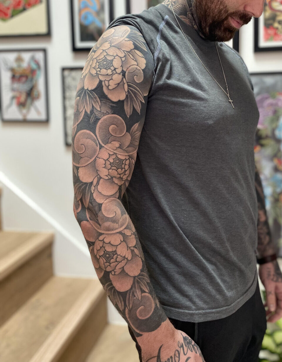 Rodrigo Souto's vibrant floral tattoo, captured in high detail, features a stunning arrangement of peony and showcases his talent for blending color and composition