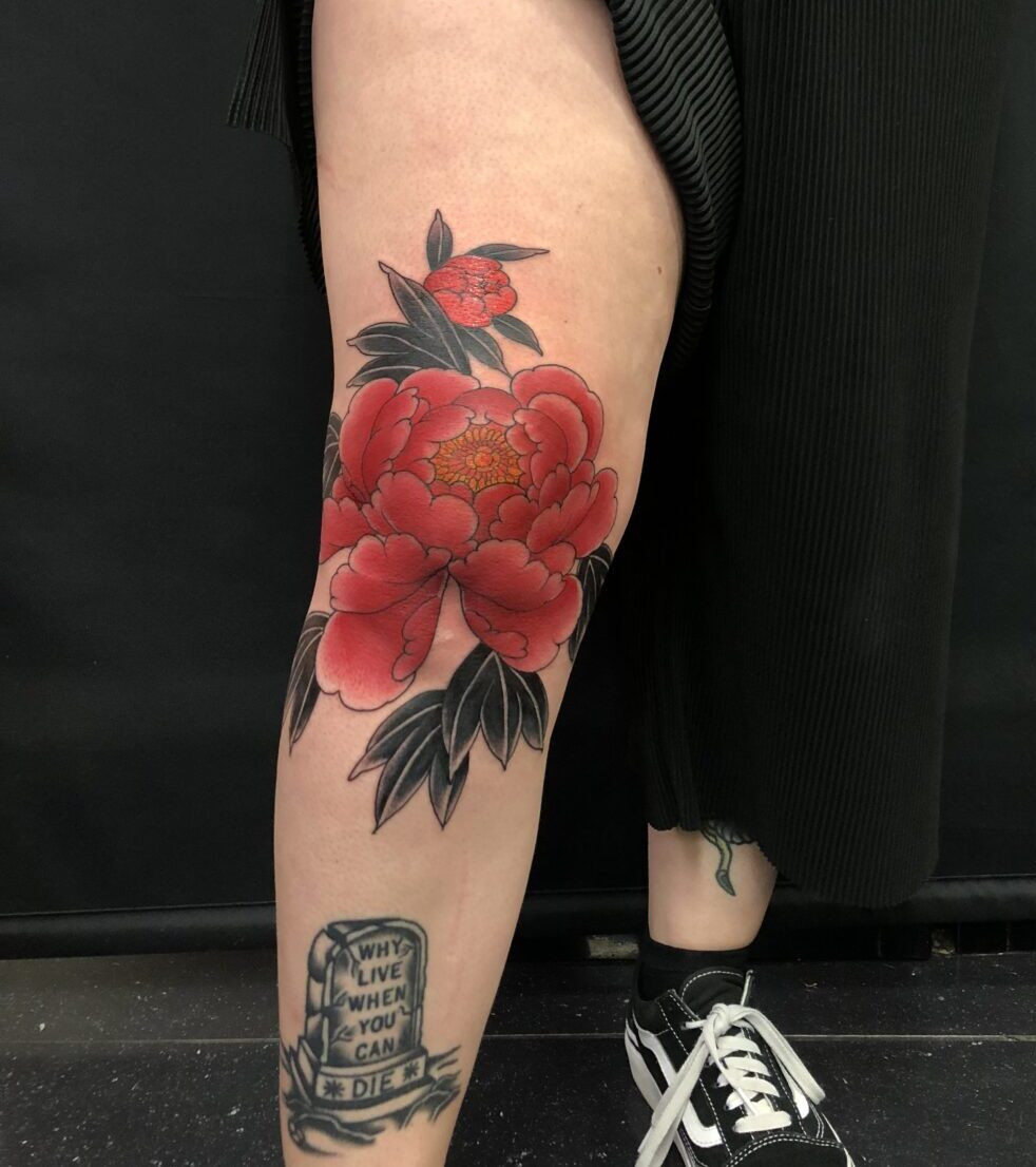 Rodrigo Souto's peony tattoo art, showcased in a vibrant shot, illustrates his unique approach to traditional themes and dedication to creating stunning body art
