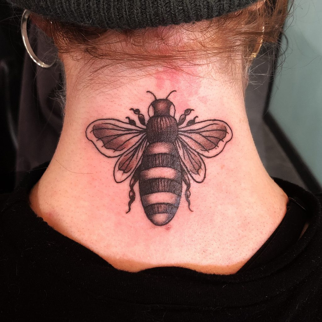 Tattoo artist working on a detailed tattoo