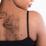woman with back tattoo