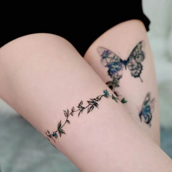 Butterfly and botanical thigh band, by @forest__tt, blending delicate beauty with natural elements