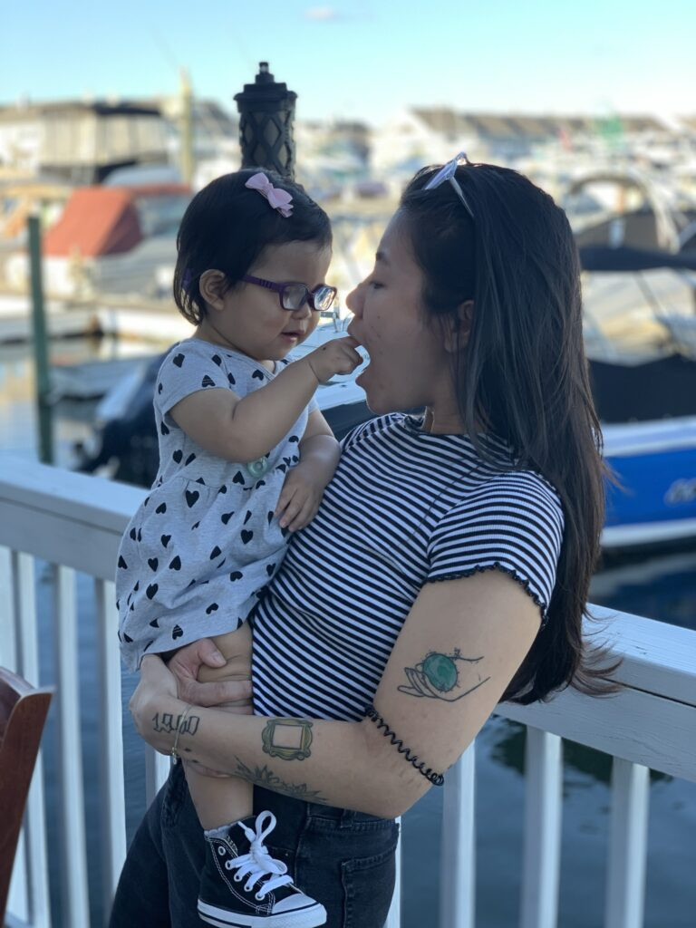 Woman's arm with a detailed black and white tattoo