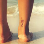A tattoo on the ankle of a woman with a small healing graze