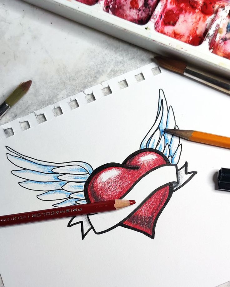 Heart with wings sketch, pencils, and watercolors on paper. Creative design and art concept.